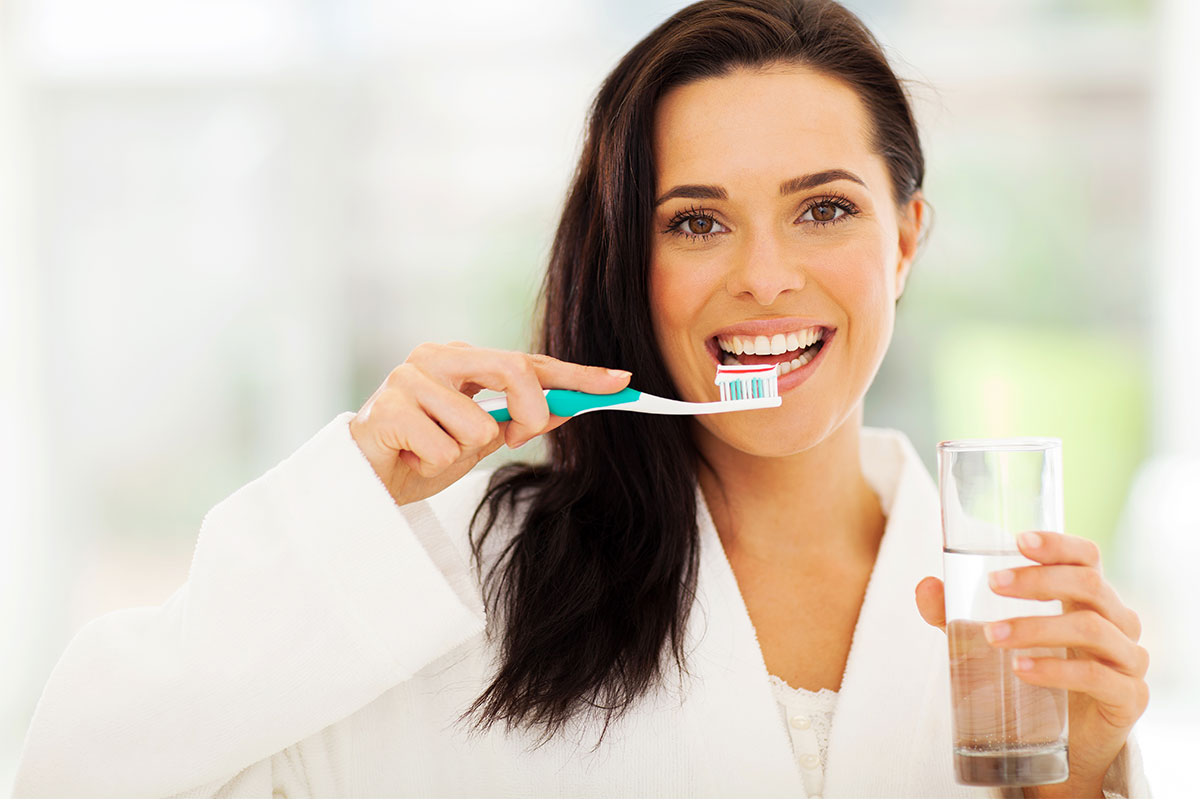 Beautiful woman smiling with tooth brush